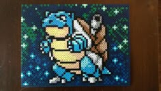 the pixel art is on display in front of a wooden frame with blue and white flowers