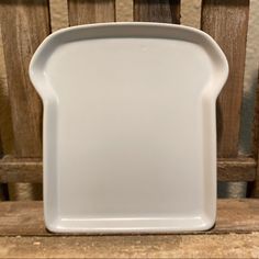 a white plate sitting on top of a wooden table