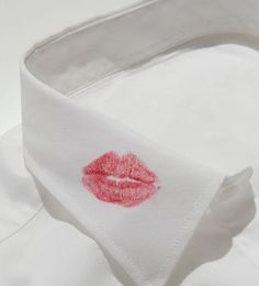 a white shirt with red lipstick on it