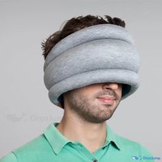 a man wearing a gray head pillow over his eyes