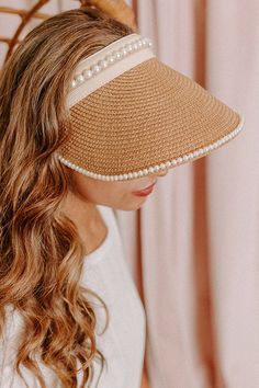 Stay protected from the sunshine while also staying stylish with this adorable tan visor featuring lightweight raffia material with delicate pearl trim detailing, an oversized brim, and an adjustable back! Chic Straw Visor Hat With Uv Protection, Chic Visor Straw Hat With Uv Protection, Chic Cream Straw Hat, Chic Straw Visor Hat, Chic Straw Visor Sun Hat, Chic Cream Straw Sun Hat, Spring Wide Brim Visor, Chic Beige Sun Hat For Day Out, Chic Spring Visor Straw Hat