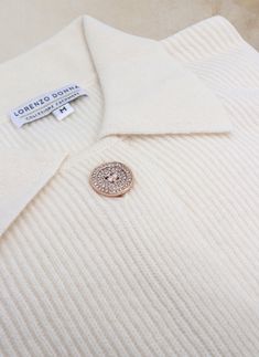 Crafted from 2 plies of our signature luxurious cashmere and merino wool blend yarn, this Marchesa knit cardigan is a sophisticated addition to any wardrobe. Sporting timeless monochromatic design and exquisite details, such as the elevated pave buttons, it makes a strong, yet understated, statement. • 70% Extra Fine Merino Wool / 30% Cashmere • Dry clean or hand wash, dry flat • Imported • Item # WF23006 SIZE & FIT• Model is 5' 9" and wearing a size Small White Cashmere Cardigan With Button Closure, Elegant White Merino Wool Cardigan, Elegant Winter Polo Sweater With Buttons, Elegant Fine Knit Button-up Sweater, Elegant Button-up Fine Knit Sweater, Elegant Wool Sweater With Buttons, Elegant Cashmere Top With Button Closure, Elegant White Merino Wool Outerwear, Elegant Beige Polo Sweater For Work