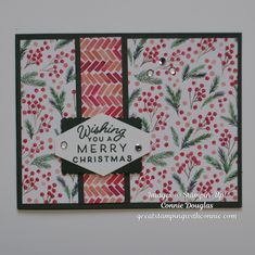 a christmas card with red berries and green leaves