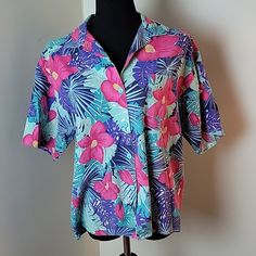 Vintage The Season Ticket Brand No Size Tag, Appears To Be About A Size M Bold Pink, Teal And Purple Tropical Flowers Hawaiian Print Buttonndown Short Sleeve Collared Blouse With Breast Pocket. Smoke Free Home F Summer Purple Shirt With Button Closure, Purple Short Sleeve Shirt For Vacation, Summer Purple Button-up Shirt, Purple Short Sleeve Vacation Tops, Purple Button-up Shirt For Summer, Purple Short Sleeve Top For Vacation, Casual Purple Floral Print Shirt, Casual Purple Shirt With Floral Print, Purple Short Sleeve Shirt With Buttons