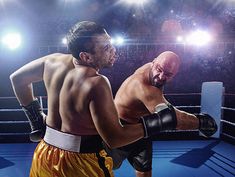 two men in boxing gloves standing next to each other