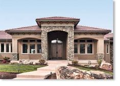 the front entrance to a home with stone and stucco