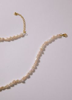 Pearl Strand White Pearl Choker With Adjustable Chain, Pearl White Shell Necklace With Pearl Chain, Elegant Pearl Chain Beaded Necklaces, White Pearl Beaded Necklace With Adjustable Chain, Elegant Pearl White Mother Of Pearl Beaded Necklaces, Pearl White Single Strand Choker Necklace, Adjustable Chain Beaded Pearl Necklace, Elegant Pearl Shell Necklace With Round Beads, Adjustable Pearl Choker Necklace