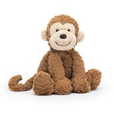 a small stuffed monkey sitting on the ground