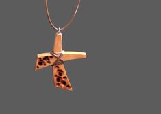 This handmade carved wooden cross necklace was made from pear wood, polished and finished with fine tung oil. This hippie style wood cross can be perfect gift for man or gift for woman. CROSS GALLERY : https://www.etsy.com/shop/NikibarsNatureArt?section_id=16787849&ref=shopsection_leftnav_5 cross height - 1 7/8 inches (47 mm) The length of the cord is about 30 inches (77 cm), but it can be regulated by the movable knot. Materials utilised: pear wood, waxed cord Production method 100% hand ma Artisan Brown Cross Jewelry, Unique Handmade Cross Necklace, Brown Wooden Beads Cross Necklace, Handmade Brown Crucifix Necklace, Brown Cross Necklace With Wooden Beads, Handmade Brown Cross Pendant Necklace, Handmade Brown Cross Necklace, Wooden Cross Necklace, Abstract Cross