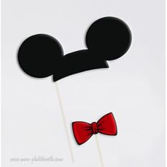 a mickey mouse cake topper with a bow tie on it