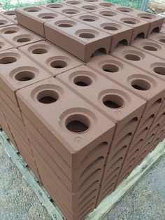 several brown bricks stacked on top of each other with holes in the middle to make them look like they are made out of clay