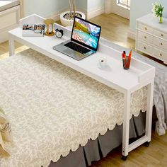 a laptop computer sitting on top of a white desk