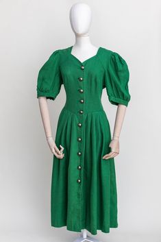 Vintage Austrian midi dress. Made of green linen. The highlight of this dress is large massive metal buttons from the front. Condition: very good vintage condition. No holes or stains. Freshly laundered and ready to wear. Fabric: 100% linen Measurements: Labeled as a size 40 EU | Best Fit: M-L All measurements are taken lying flat and have already been doubled shoulders: 38 cm | 15'' breast: 102 cm | 40'' waist: 88 cm | 35'' length: 122 cm | 48'' Green Vintage A-line Midi Dress, Vintage Linen Midi Dress, Green Linen Dress With Buttons, Vintage Fitted A-line Linen Dress, Vintage Buttoned Midi Dress For Spring, Vintage Green A-line Midi Dress, Vintage Knee-length Linen Dress For Spring, Green A-line Vintage Midi Dress, Retro Green Dress With Buttons