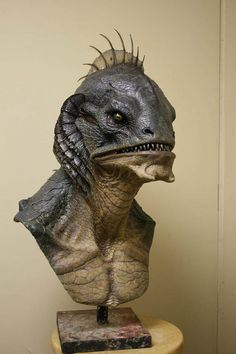 a close up of a statue of a dinosaur with spikes on it's head