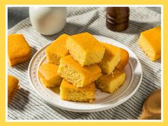 a plate full of cornbreads on a table next to a bottle of milk