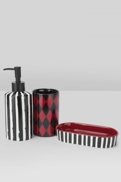 three bathroom accessories including a soap dispenser, toothbrush holder and dish