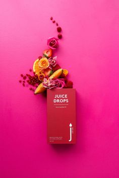 the juice drops book is surrounded by flowers on a bright pink background with an arrow pointing to it