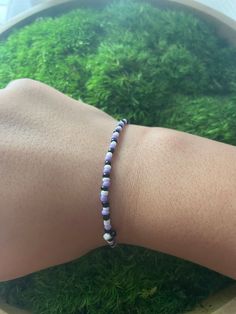 The perfect kids bracelet made with purple, white, and black seed beads Beaded Bracelet Purple, Beaded Purple Bracelets, Purple Friendship Bracelets With Spacer Beads, Casual Purple Friendship Bracelets With Round Beads, Casual Purple Round Beads Friendship Bracelets, Casual Purple Beaded Friendship Bracelets, Purple Beaded Bracelets For Everyday, Casual Purple Stretch Bracelet For Everyday, Adjustable Casual Purple Beaded Bracelets