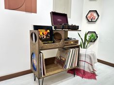 an old record player is sitting on top of a bookcase in the corner of a room