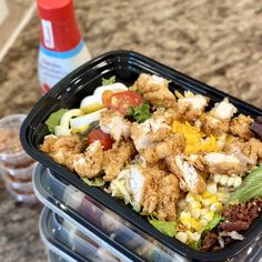 two plastic containers filled with food on top of a counter