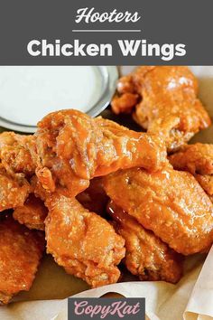 chicken wings with sauce on top and the words, how to make hooter's chicken wings