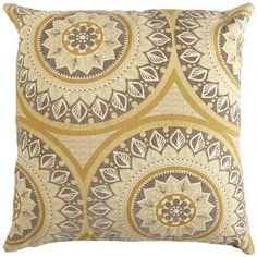 a yellow and brown pillow with circular designs on it