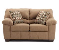 a brown couch with two pillows on it