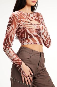 Mesh is all the rage, and out Aria top is at the top of the list! This top has a sheer abstract print mesh construction, long sleeves, a cropped fit, and a ring finger loop. A basic without being basic, our Aria top can be worn with jeans, pants, skirts, or shorts! Cropped Tops With Sheer Sleeves For Fall, Sheer Cropped Mesh Top For Fall, Trendy Sheer Cropped Top, Trendy Sheer Long Sleeve Crop Top, Trendy Cropped Top With Mesh Sleeves, Trendy Cropped Mesh Top For Fall, Sheer Long Sleeve Top, Pants Skirts, Sheer Long Sleeve