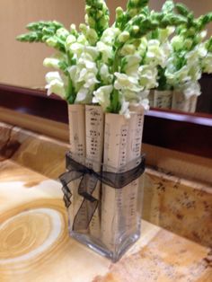 a vase filled with flowers sitting on top of a counter