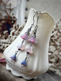 o*. ✿ .*o Fairy Bell Flower Earrings o*. ✿ .*o ✿ About This Pair ✿ --Length: approximately 2.75" long. --Antique silver with pale pink and lavender Czech glass bell flower beads. --Featuring graceful round silver finished stainless steel ear wires. Whimsical Dangle Flower Earrings, Whimsical Silver Flower Earrings, Whimsical Silver Flower Earrings With Ear Wire, Silver Whimsical Flower Earrings, Whimsical Nickel Free Dangle Flower Earrings, Whimsical Silver Dangle Flower Earrings, Whimsical Adjustable Nickel-free Flower Earrings, Whimsical Handmade Silver Flower Earrings, Pink And Lavender