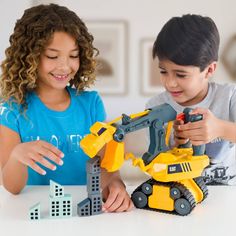 two children are playing with toys on the table