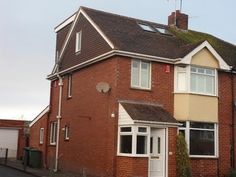 a red brick house with white trim and windows