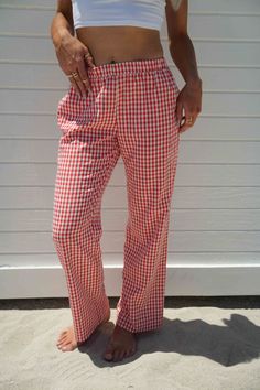 Score trendy Gingham Pants made of cotton canvas in a red check pattern. Designed with a comfy fit and a low waist, these bottoms will elevate your look when worn with a top and stylish boots or heels. pants 50% cotton 50% polyester lininig 100% rayon gingham print inner drawstring tie elastic waistband double pocket at back non stretch fully lined models are both wearing size medium Plaid Cotton Bottoms With Elastic Waistband, Gingham Cotton Pants, Summer Plaid Loungewear Pants, Summer Plaid Pants For Loungewear, Casual Gingham Cotton Bottoms, Casual Gingham Trousers, Plaid Cotton Straight Leg Pants, Plaid Straight Leg Cotton Pants, Red Bottoms For Spring Picnic