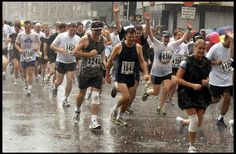 a large group of people running in the rain