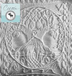 a white crocheted blanket with an image of a bird on it's back