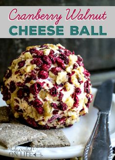 cranberry walnut cheese ball on a plate with crackers