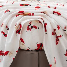 a white blanket with red and black designs on it