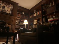 a living room filled with furniture and bookshelves covered in lots of bookcases