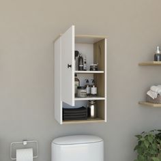 a white toilet sitting in a bathroom next to a wall mounted cabinet with shelves above it