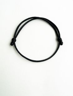 Black rattail satin cord mens bracelet - husband gift This handmade bracelet is made using 2mm thick rattail black satin cord. It is easily adjusted to fit any size of wrist comfortably. Similar rattail bracelet: https://www.etsy.com/listing/230001118/kabbalah-red-braceletsimple?ref=shop_home_active_5&ulsfg=true More string bracelets in my shop: https://www.etsy.com/shop/LuckyRatJewellery?section_id=16685466&ref=shopsection_leftnav_2 *Colours may differ slightly from the original due to Cheap Adjustable Black Wristband, Everyday Black Bracelets With Nylon Cord, Black Nylon Cord Braided Bracelet For Everyday, Everyday Black Braided Nylon Bracelets, Everyday Black Nylon Cord Friendship Bracelets, Simple Adjustable Black Bracelets, Everyday Bracelets With Sliding Knot And Nylon Cord, Adjustable Friendship Bracelets For Everyday, Black Adjustable Friendship Bracelets As A Gift