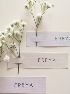 three different types of labels with flowers in them on the wall next to each other