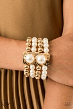 WEALTH-Conscious - Gold Held in place with a hammered gold frame dotted with two oversized white pearls, strands of classic gold beads and white pearls are threaded along stretchy bands that wrap around the wrist in a glamorously layered look. Sold as one individual bracelet. Paparazzi Fashion, Gold Stretch Bracelet, October Fashion, Gold Pearl Bracelet, Streets Of New York, 5th Avenue, Pearl Design, Hammered Gold, Paparazzi Accessories