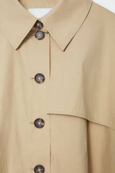 CROPPED TRENCH COAT CAPE - LIGHT BEIGE - COS Workwear Cape With Button Closure, Workwear Cape Outerwear With Button Closure, Spring Workwear Cape, Cape-style Buttoned Outerwear For Work, Modern Cape For Workwear, Modern Workwear Cape Outerwear, Modern Cape-style Workwear Outerwear, Modern Cape Outerwear For Work, Oversized Beige Cape Outerwear