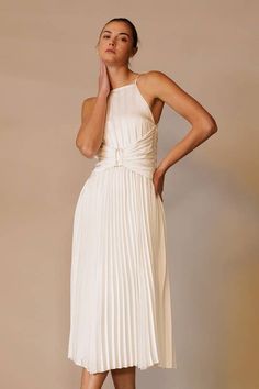 Elevate your formal attire with the Marilyn White Pleated Midi Dress. Featuring an apron neck, modern corset waist, and back tie, this plisse dress adds allure to any event. With its sophisticated design and charming details, you'll feel confident and polished. Perfect for both formal events and cocktail parties. Fitted Bridesmaid Midi Dress With Tie Back, Chic A-line Maxi Dress For Banquet, Elegant Evening Dress With Pleated Back For Banquet, Elegant Fitted Pleated Cocktail Dress, Fitted Midi Dress With Accordion Pleats For Evening, Elegant Pleated Summer Evening Dress, Elegant Pleated Evening Dress For Summer, Fitted Accordion Pleats Midi Dress For Evening, Fitted Midi Length Pleated Dress For Wedding