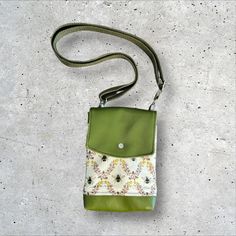 This minimalist crossbody is perfectly compact and is as well suited for a day of errands as it is for travelling.  Beneath a flap that snaps closed you will find the main slip compartment, which keeps essentials like phones, mid-sized wallets, earbuds, and keys handy, as well as a slimmer slip pocket.  The slimmer slip pocket under the flap and the back slip pocket are both ideal for thinner items like card wallets, lip balm, and more.  This features an adjustable crossbody strap which is also Green Pouch Phone Bag For Travel, Green Everyday Use Phone Pouch Bag, Green Pouch Phone Bag For Everyday Use, Green Travel Pouch Phone Bag, Green Bag With Cell Phone Pocket As Gift, Green Bag With Cell Phone Pocket For Gift, Green Crossbody Travel Pouch, Green Phone Bag With Removable Pouch For Travel, Green Crossbody Pouch