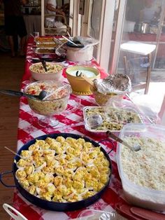 a long table covered with lots of food and bowls filled with different types of foods