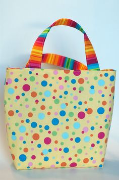 a multicolored polka dot bag on a white background with colorful stripes and dots