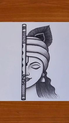 a drawing of a woman's face with a feathered headdress on