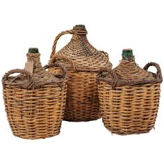 three wicker baskets with lids and handles are shown in front of a white background