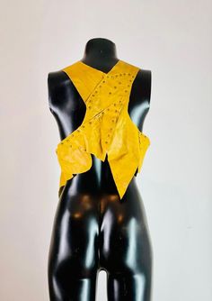 Yellow leather women's biker vest. Handmade unique design. Sleeveless jacket created with genuine leather and brass staples. - The product was produced in adjustable size and as one only.  - Made using surplus leather parts. - XS / S / M Adjustable Size - Ships in 1/3 business day. It reaches all over the world within 7 days after the shipping day at the latest. Fitted Vest For Fall Concert, Edgy Fitted Vest For Festivals, Fitted Leather Jacket For Stylish Wear, Punk Style Sleeveless Leather Vest, Biker Sleeveless Vest For Festivals, Biker Style Sleeveless Vest For Festivals, Leather Sleeveless Vest For Festivals, Fitted Leather Festival Vest, Sleeveless Biker Vest For Alternative Fashion